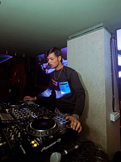 Another angle of me at the decks, surrounded by the club's visual setup.