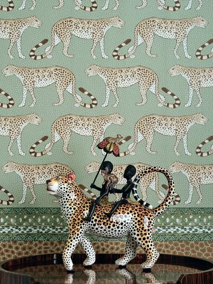 Elevate your space with the bold elegance of Cole & Son’s leopard wallpaper. The repeating pattern of leopards on a sage green background transforms this interior into a sophisticated sanctuary where style roams free.