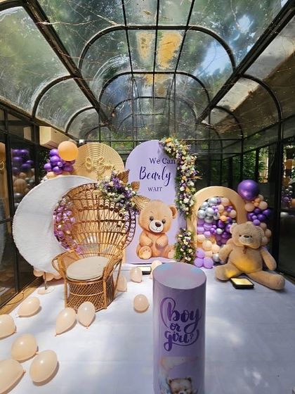 A full view of the 'We Can Bearly Wait' baby shower setup in a stunning glasshouse venue.