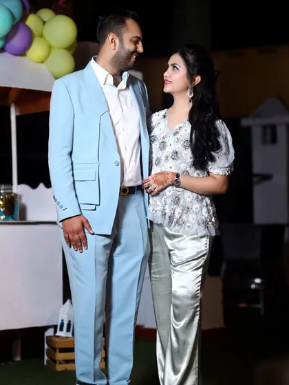 A candid couple portrait where they share a look, captured in a relaxed moment during the birthday festivities.