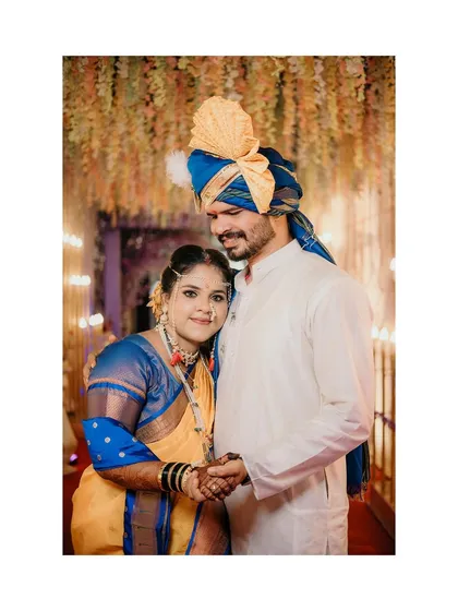 A tender moment between the bride and groom. Dressed in traditional Maharashtrian attire, they share a quiet look, a memory we've preserved for them.
