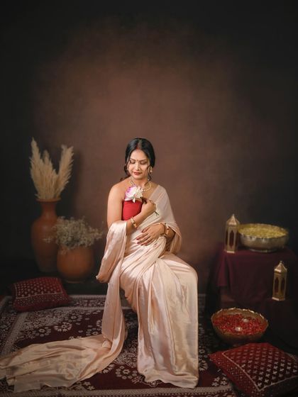 A quiet moment of connection. The mom to be holds a flower to her belly, symbolizing the new life blooming within.