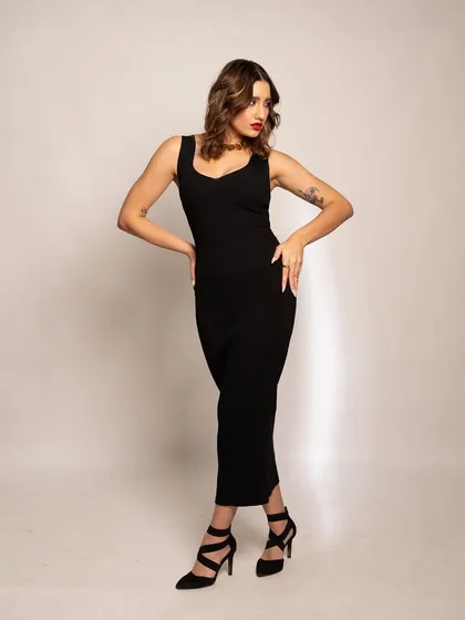 The complete iconic look. The combination of a sleek black dress, a bold red lip, and confident posing creates a timeless and powerful image.