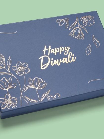 A blue and gold foil version of the "Happy Diwali" gift box. We take special care to capture the shine of foil stamping without harsh glare.
