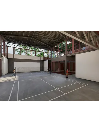 The indoor badminton court, designed with high ceilings and clerestory windows that bring in natural light without glare. The space is visually connected to the rest of the campus, reinforcing the theme of interconnectedness.