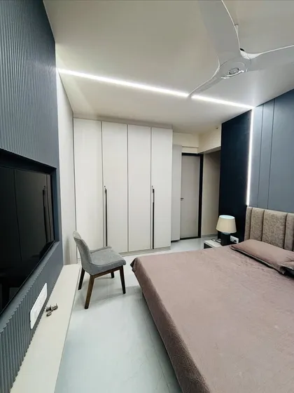 A minimalist bedroom featuring a six-door, floor-to-ceiling wardrobe in a clean white finish. The long, sleek handles add a touch of modern elegance, complementing the room's serene and uncluttered design.