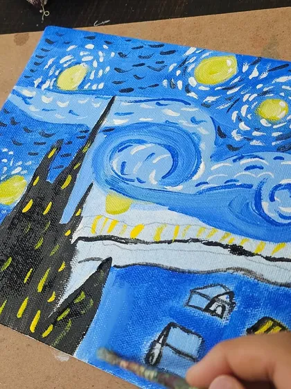 A close-up of the brushstrokes and colors used to recreate the iconic 'Starry Night'.