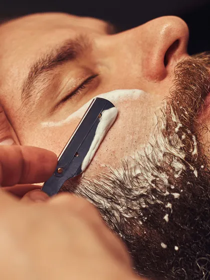 Experience the classic straight razor shave, a ritual of refinement. We use hot towels and premium balms to deliver an impeccably close and comfortable shave, leaving your skin smooth and revitalized.