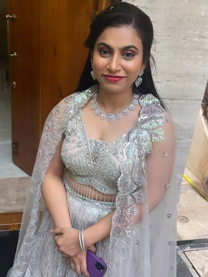 The client looking lovely and ready for her event in a silver lehenga.