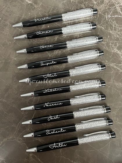 A quality pen makes a statement. These sleek black pens feature a crystal accent and are personalized with individual names, making them an elegant and practical corporate gift for employees or clients.