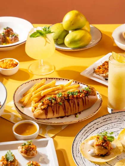 A bright and sunny spread for a mango festival menu. The yellow background and fresh mangoes tie the whole theme together.