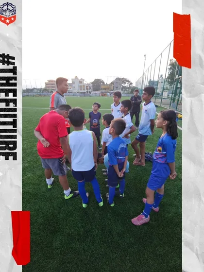 Team talks are a vital part of learning. A coach gathers our young players for a huddle to discuss tactics and strategy, building their understanding of the game.