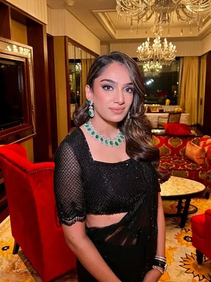A confident and glamorous portrait. The makeup for this look was all about creating a powerful, elite vibe with black, glitter, and emeralds.