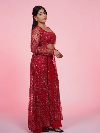 Another look at the red three-piece Indo-Western set, showing how the sheer jacket adds a touch of elegance to the bold color.
