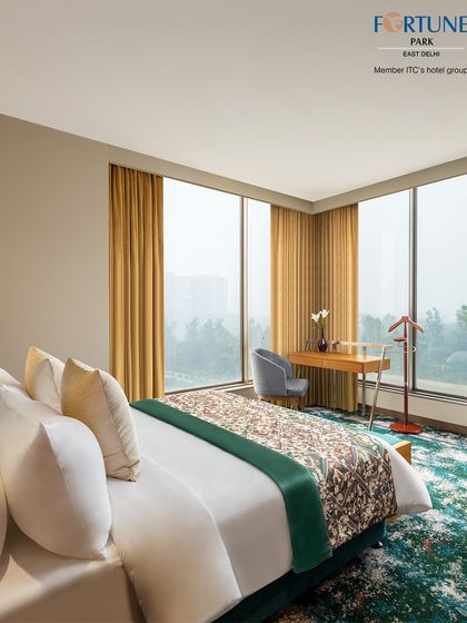 Our rooms with corner windows provide panoramic views of the city. This setup includes a comfortable bed and a dedicated work desk, ideal for business travelers.