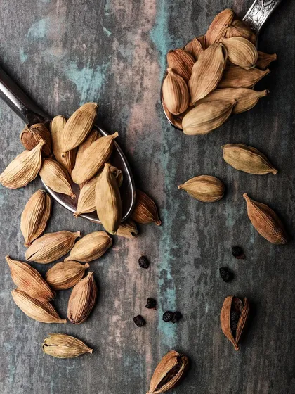 A detailed macro shot of cardamom pods. Close up shots like this highlight the quality of ingredients and add a sensory dimension to food photography.