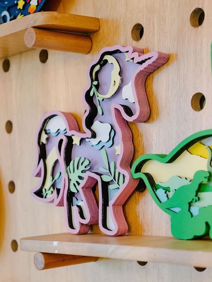 A close-up of some of the beautiful layered wooden art pieces we offer. I keep a variety of finished examples on display around the studio to inspire our guests and show them what's possible.