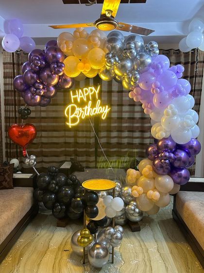 A different view of the multi-colored balloon arch, showing how it frames the living room space.
