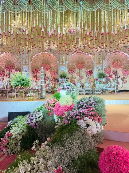 A view of the regal, pastel-palette mandap from the side, showing the lush floral landscape we created to frame the stage. Every corner was designed to be fragrant and majestic. 🪷