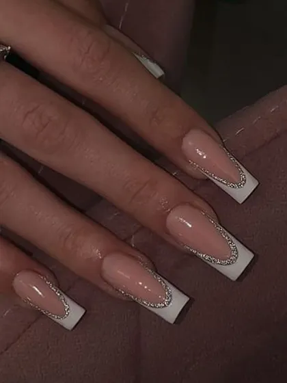 A glamorous French manicure on square nails, where the classic white tip is outlined with a fine line of silver glitter for extra sparkle.
