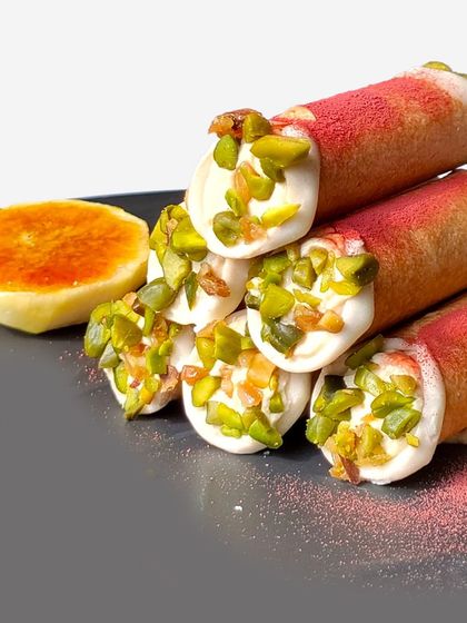 Our mishti doi cannoli, filled with sweetened yogurt and crusted with pistachios, is served with tandoori figs. It's the perfect way to add a little extra warmth to your celebrations.