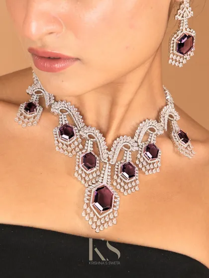 While we are rooted in tradition, we also cater to modern tastes. This American Diamond necklace with deep purple stones is an example of our contemporary collection, perfect for evening wear and cocktail events.