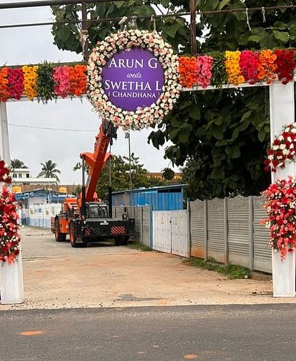 We can create large-scale entrance structures for any venue. This welcome gate for a reception features a large floral crest with the couple's names and custom banners, making a grand statement from the road.