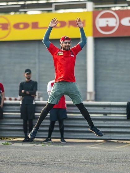 A coach leads by example during a fitness warm-up. We believe a fit rider is a better rider, and we integrate physical conditioning into our programs.