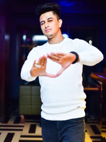 Making the triangle sign, a symbol of connection and energy. It's all about creating a unified vibe.