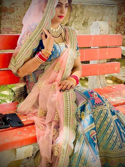 Another angle of the Doli Barat lehenga, highlighting the flow of the sheer pink dupatta and the intricate details on the skirt.