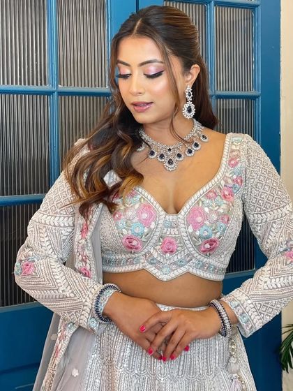 A modern, fashion-forward look featuring a pearl-encrusted gown. The simple diamond drop earrings are the perfect accessory for this statement outfit.