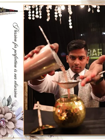 A bartender strains a freshly shaken cocktail into a unique gol-gappa style glass, showcasing our creative presentation.