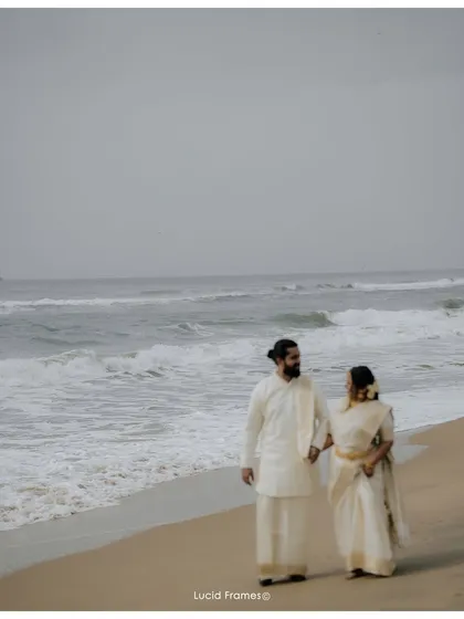 A cinematic walk along the serene Kerala coastline. This frame showcases our love for destination wedding photography, blending the grandeur of the landscape with the intimacy of the couple's journey.