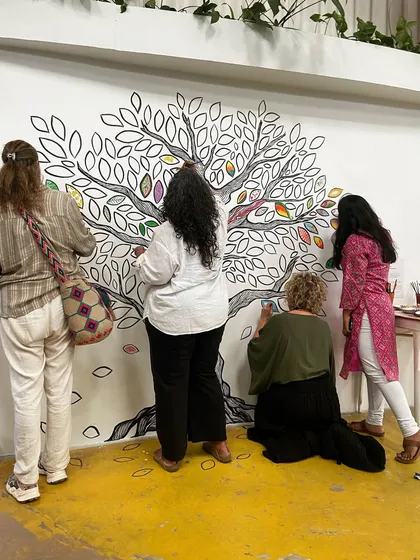 The 'Mosaic of Us' tree mural was a collaborative piece created during the Hearth Summit. I painted the outline, and attendees brought it to life by coloring in the leaves. It stands as a beautiful symbol of how individual contributions create a vibrant, collective whole.