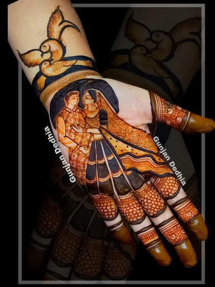 A beautiful portrait of a bride and groom, framed by delicate henna work. The addition of lovebirds on the wrist symbolizes their new journey together.