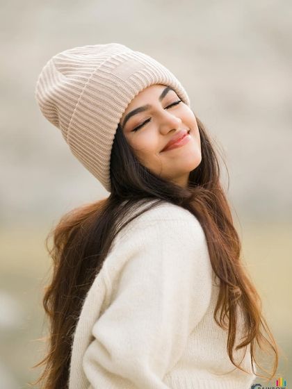 A candid, smiling shot that feels warm and genuine, perfect for a lifestyle winter campaign.