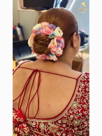 A close-up of the multi-colored floral bun, a vibrant and joyful choice for a bride.