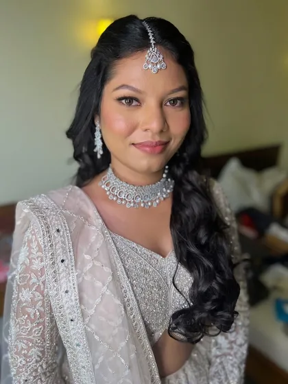 Radiance from within, elegance from every angle. A flawless glow for this beautiful engagement bride in her white lehenga.