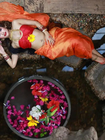 Another high-angle shot from our 'Lahu Munh Lag Gaya' series, this time incorporating a bowl of flowers in water. This composition adds color and a touch of serenity to the powerful theme.