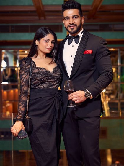 A client looking dapper in a classic black tuxedo at an evening event. The fit is sharp, the style is timeless, and it demonstrates how a well-made tuxedo is the ultimate choice for life's celebratory moments.