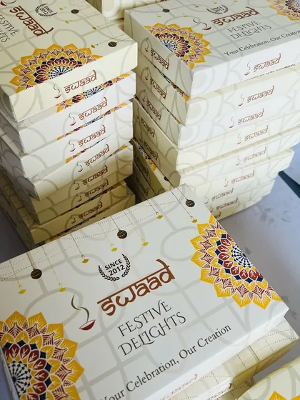 We are fully equipped to handle large-scale corporate gifting orders. This image shows stacks of our custom-branded 'Festive Delights' boxes ready for dispatch, a popular choice for companies during Diwali and other celebrations.