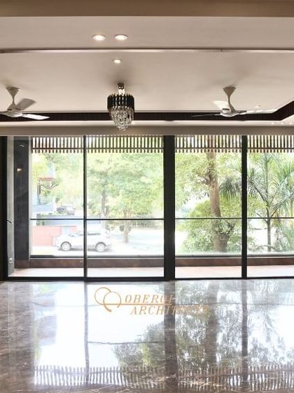 The raw space, ready for transformation. This shows the potential of a well-designed architectural layout, with features like a marble-clad fireplace base and elegant wall paneling already in place.