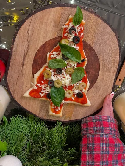 Who says pizza can't be festive? At my holiday workshops, we get creative with fun shapes like this Christmas tree pizza, made from scratch with fresh toppings.