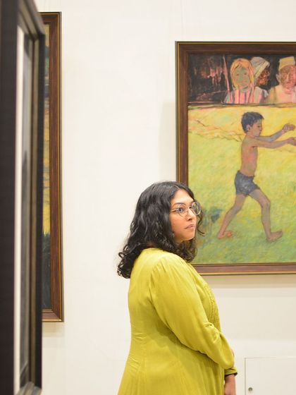 Another candid moment from our exhibition, capturing a visitor's engagement with a painting. It's moments like these that remind us why we do what we do.