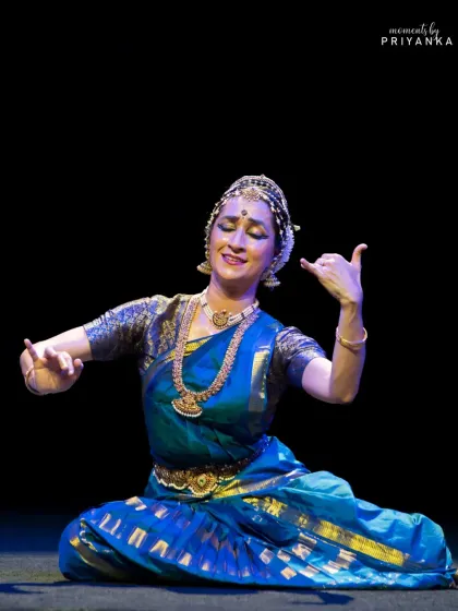A seated pose that conveys a sense of playfulness and charm, characteristic of many Kuchipudi pieces.