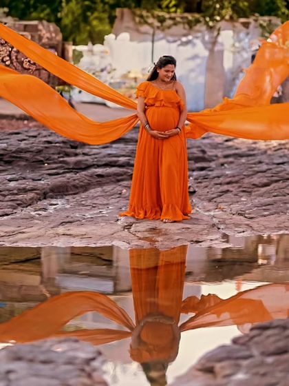 Our mustard georgette gown features four separate trails for a unique, wing-like effect. It's a vibrant and dynamic choice for a memorable maternity or pre-wedding shoot.