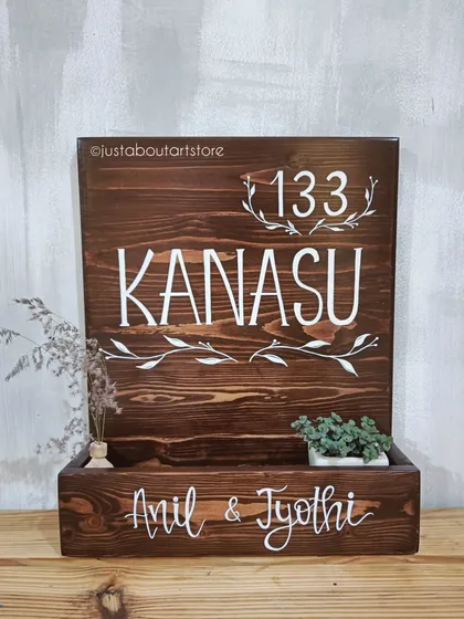 Our "Kanasu" name plaque, meaning 'dream' in Kannada, features a planter box to hold little succulents. It's a living piece of art for your home's entrance.