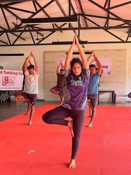A warrior's strength comes from balance. We incorporate yoga into our camps to improve flexibility, focus, and recovery. Here, our students practice the Tree Pose (Vrikshasana) to build stability and mental calm.