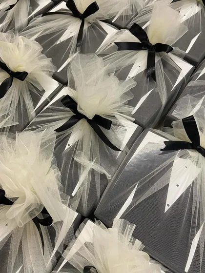 The final presentation of our 'Suit Up' groomsmen hampers. Each box is wrapped in delicate white tulle with a black ribbon, resembling a tuxedo and adding a touch of class.