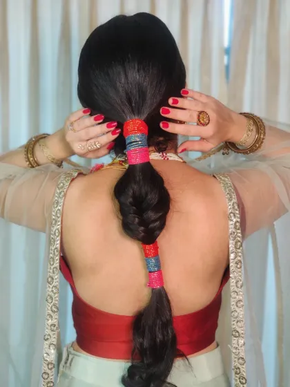 A close up of the colorful lace adorned braid we created for Bhawna's Mehendi. This is a fun and unique way to add a pop of color to your hairstyle.